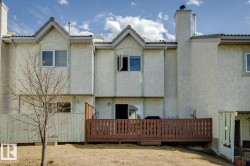 Stucco exterior with multiple gables and a private wooden deck - 