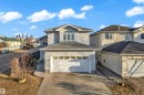 Two-story home with light grey siding, an arched window feature, an attached two-car garage, and a concrete driveway - 4103 37A Avenue, Edmonton, AB  - Outdoor 