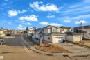 Modern multi-story property featuring light-colored siding, a prominent two-car garage with white doors, and a concrete driveway - 4103 37A Avenue, Edmonton, AB  - Outdoor 