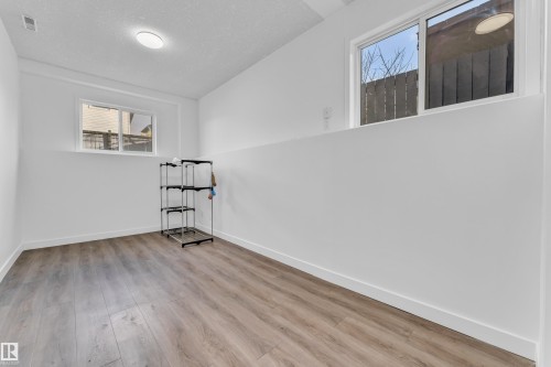 Spacious interior with wood-finish flooring and white baseboards - 4103 37A Avenue, Edmonton, AB - Indoor Photo Showing Other Room