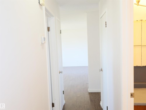 Hallway with white walls and wood-finish flooring - 4934 49 Avenue, Barrhead, AB - Indoor Photo Showing Other Room