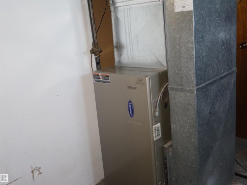 Carrier brand furnace and galvanized steel ductwork - 4934 49 Avenue, Barrhead, AB - Indoor Photo Showing Basement
