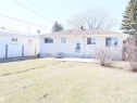 Rear exterior featuring a concrete patio, stucco siding, and a gabled roof - 4934 49 Avenue, Barrhead, AB  - Outdoor 