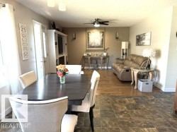 Dining area with dark wood-finish table and upholstered chairs - 