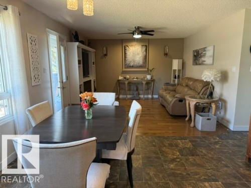 Dining area featuring durable tile flooring, a built-in media cabinet, and a ceiling fan - 356 Weber Way, Edmonton, AB - Indoor Photo Showing Dining Room