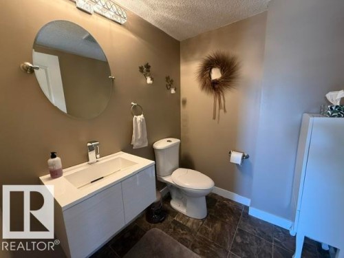 Contemporary bathroom featuring a floating white vanity with an integrated sink and chrome faucet - 356 Weber Way, Edmonton, AB - Indoor Photo Showing Bathroom