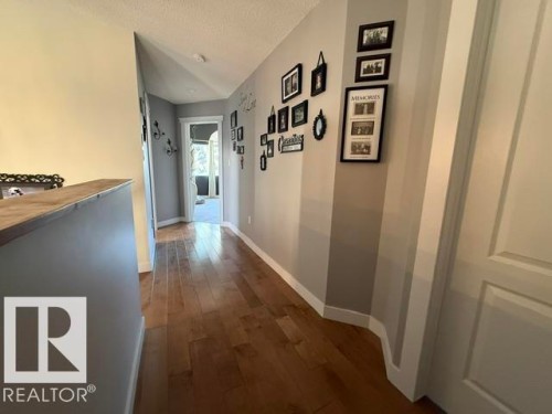 Hallway featuring wood-finish flooring, light gray wall paint, white baseboards, and white ceiling - 356 Weber Way, Edmonton, AB - Indoor Photo Showing Other Room