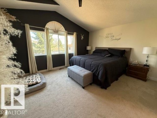 Vaulted ceiling room featuring three large windows, a semicircular transom window, and light-toned carpeting - 356 Weber Way, Edmonton, AB - Indoor Photo Showing Bedroom