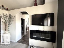 Wall-mounted electric fireplace featuring a glass front and crystal media - 