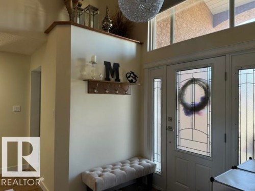Entryway featuring a decorative front door with frosted glass panels and transom windows - 356 Weber Way, Edmonton, AB - Indoor Photo Showing Other Room