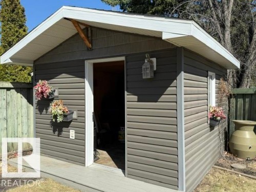 Detached outbuilding with horizontal siding, a white soffit, and a light-colored trim - 356 Weber Way, Edmonton, AB - Outdoor With Exterior