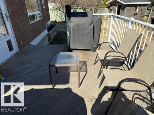 Expansive outdoor deck featuring wood flooring, white railing, and exterior access to the property - 356 Weber Way, Edmonton, AB - Outdoor With Exterior