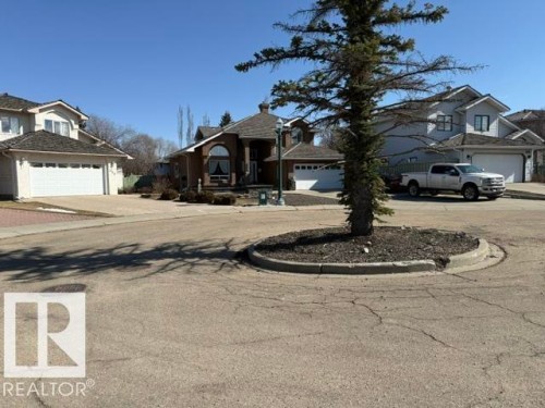 Brick-front residence with an arched window accent, prominent front entry, and attached garage - 356 Weber Way, Edmonton, AB - Outdoor