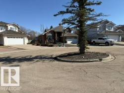 Brick-front residence with an arched window accent, prominent front entry, and attached garage - 