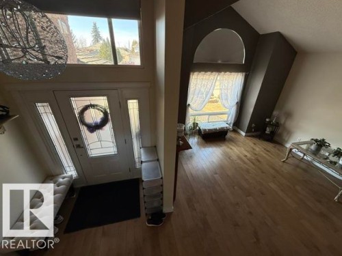 Two-story entryway with a decorative glass-paneled entry door, sidelights, and transom window - 356 Weber Way, Edmonton, AB - Indoor Photo Showing Other Room