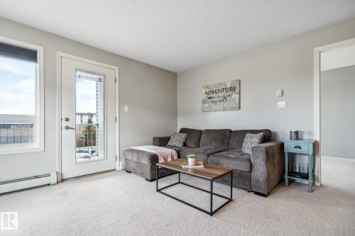 Neutral-toned walls complement plush carpeting - 1306 330 Clareview Station Drive, Edmonton, AB - Indoor Photo Showing Living Room