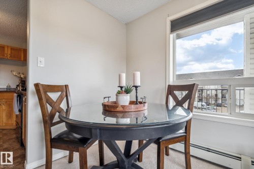 Dining area featuring a large window, light-colored walls, and carpeting - 1306 330 Clareview Station Drive, Edmonton, AB - Indoor Photo Showing Dining Room