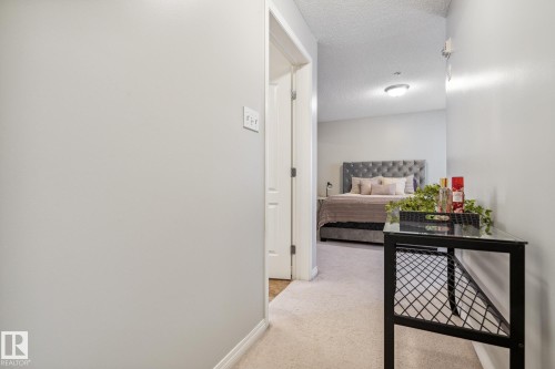 Plush carpeted hallway with light neutral walls and white trim - 1306 330 Clareview Station Drive, Edmonton, AB - Indoor Photo Showing Other Room