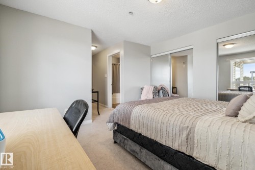 Bedroom featuring neutral tone carpeting and light gray wall paint - 1306 330 Clareview Station Drive, Edmonton, AB - Indoor Photo Showing Bedroom