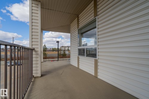 Private balcony featuring a concrete floor, metal railings, and a large window - 1306 330 Clareview Station Drive, Edmonton, AB - Outdoor With Exterior