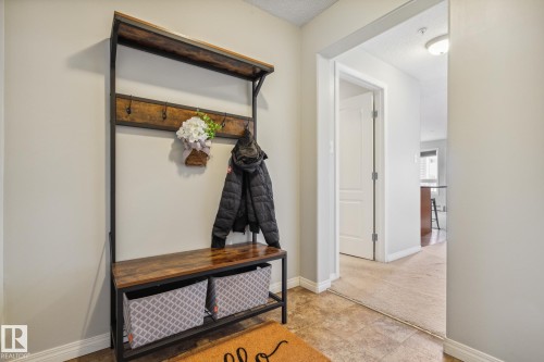 Entryway featuring light neutral wall paint, wood-finish flooring, and white baseboards - 1306 330 Clareview Station Drive, Edmonton, AB - Indoor Photo Showing Other Room