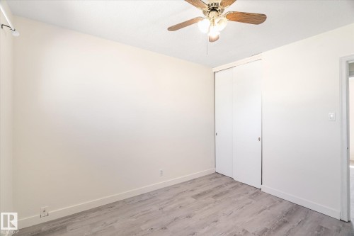 Room featuring wood-finish flooring, light-colored walls, and a ceiling fan with light fixture - 10531 128 Avenue, Edmonton, AB - Indoor Photo Showing Other Room