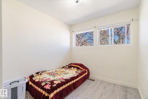 Room featuring light wood-finish flooring and neutral wall paint - 10531 128 Avenue, Edmonton, AB - Indoor Photo Showing Bedroom