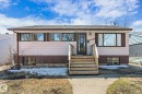 Split-level residence featuring light-colored siding with a dark brown foundation - 10531 128 Avenue, Edmonton, AB  - Outdoor 