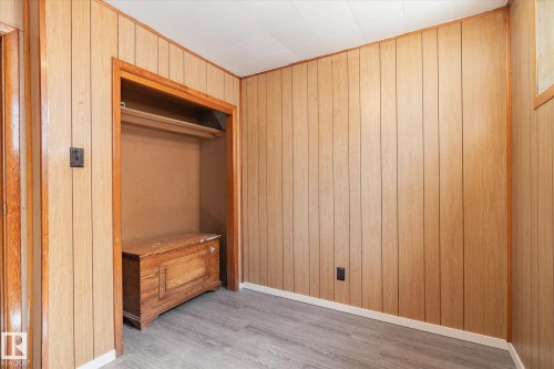 Light-toned wood paneling walls throughout, complemented by wood-finish flooring - 10531 128 Avenue, Edmonton, AB - Indoor Photo Showing Other Room