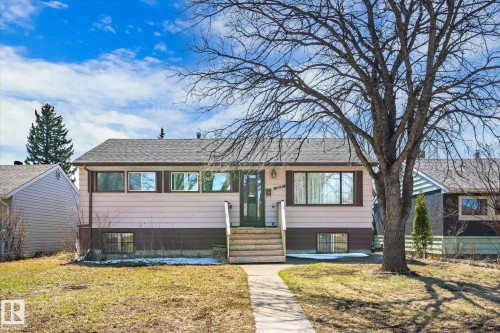 Single-story residence featuring a brown shingle roof, light-colored siding, and a dark brown foundation - 10531 128 Avenue, Edmonton, AB - Outdoor
