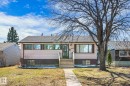 Single-story residence featuring a brown shingle roof, light-colored siding, and a dark brown foundation - 10531 128 Avenue, Edmonton, AB  - Outdoor 