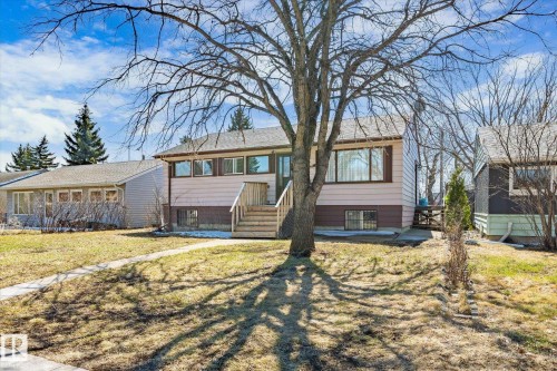 Split-level residence featuring a light-colored upper siding and a darker lower-level finish - 10531 128 Avenue, Edmonton, AB - Outdoor
