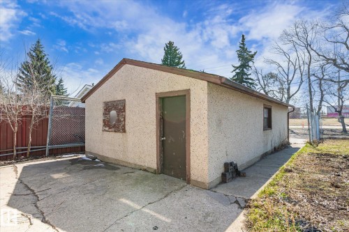 Detached outbuilding with an exterior finish, a side entry door, and a small side window - 10531 128 Avenue, Edmonton, AB - Outdoor