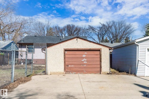Detached garage with a textured stucco exterior and a sectional overhead door - 10531 128 Avenue, Edmonton, AB - Outdoor With Exterior