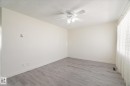 Interior room featuring light-toned walls, wood-finish flooring, and white baseboards - 10531 128 Avenue, Edmonton, AB  - Indoor Photo Showing Other Room 