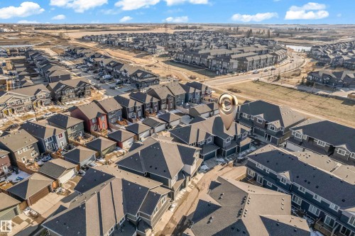 Aerial perspective showcasing a residential development with individual houses and multi-unit buildings - 41 603 Orchards Boulevard, Edmonton, AB - Outdoor With View