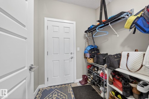 White panel doors, neutral wall paint, and a textured ceiling - 3639 15A Street, Edmonton, AB - Indoor