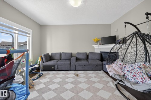 Living area with light neutral wall paint and a large window - 3639 15A Street, Edmonton, AB - Indoor Photo Showing Living Room