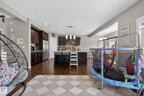 Open-concept living space with dark wood-finish flooring - 3639 15A Street, Edmonton, AB - Indoor