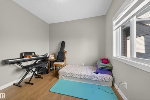 Room featuring light grey painted walls and wood-finish flooring - 3639 15A Street, Edmonton, AB - Indoor Photo Showing Bedroom