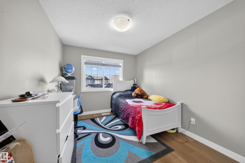 Neutral gray wall paint with white trim, wood-finish flooring, and a single window offering exterior views - 3639 15A Street, Edmonton, AB - Indoor