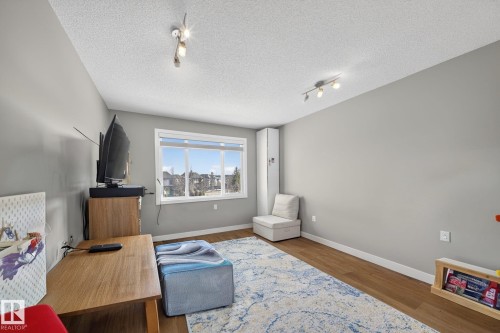 Bright room with light gray walls and wood-finish flooring - 3639 15A Street, Edmonton, AB - Indoor