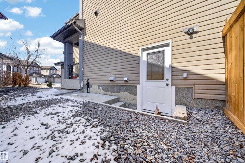 Rear exterior entry featuring a glass-paneled door and a concrete landing - 3639 15A Street, Edmonton, AB - Outdoor