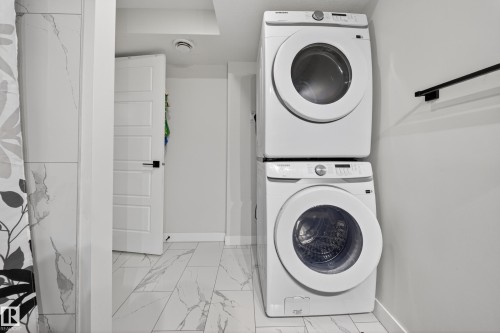 Stackable front-load washer and dryer set - 3639 15A Street, Edmonton, AB - Indoor Photo Showing Laundry Room