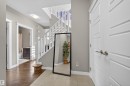 Entryway featuring a tiled floor and an open staircase with white balusters - 3639 15A Street, Edmonton, AB  - Indoor Photo Showing Other Room 