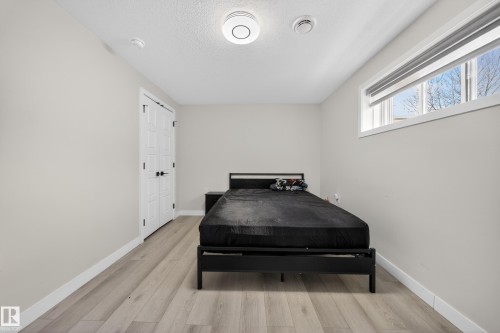 Neutral wall color with wood-finish flooring - 3639 15A Street, Edmonton, AB - Indoor Photo Showing Bedroom