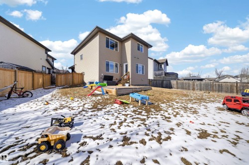 Spacious backyard featuring a multi-level composite deck, beige vinyl siding, and wood privacy fencing - 3639 15A Street, Edmonton, AB - Outdoor