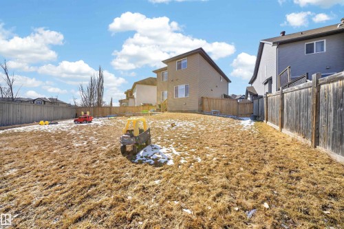 Expansive backyard featuring a full perimeter wood fence and a gradual incline - 3639 15A Street, Edmonton, AB - Outdoor