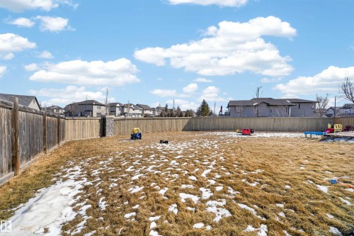 Spacious backyard featuring a full perimeter wooden fence and a stone pillar accent - 3639 15A Street, Edmonton, AB - Outdoor