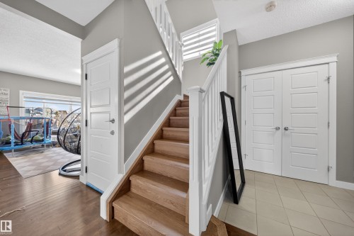 Wood-finish staircase with white balusters - 3639 15A Street, Edmonton, AB - Indoor Photo Showing Other Room